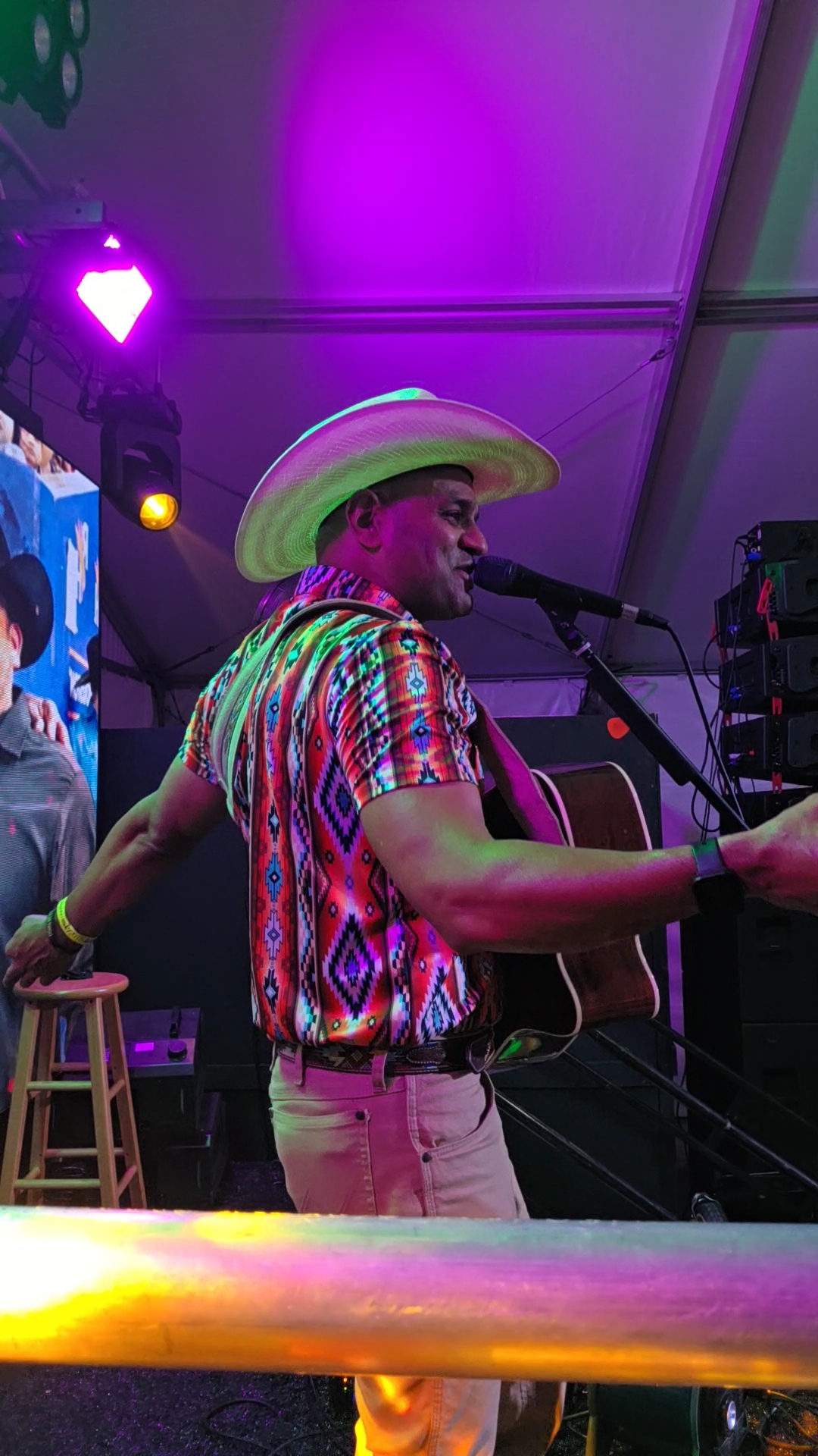 Nigel singing in a straw cowboy hat