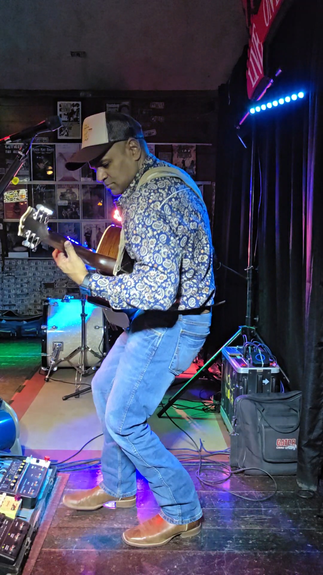 Nigel leaning into a guitar solo on stage